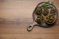 Delicious pickled capers and rosemary twigs on wooden table, top view. Space for text Royalty Free Stock Photo