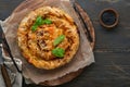 Delicious pie Spanakopita with soft feta cheese and spinach on old dark wooden table backgrounds. Traditional Greek Spiral filo Royalty Free Stock Photo