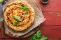 Delicious pie Spanakopita with soft feta cheese and spinach on old red wooden table backgrounds. Traditional Greek Spiral filo Royalty Free Stock Photo