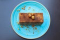 Delicious piece of cake with nuts on a blue plate. Top view Royalty Free Stock Photo