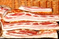 A delicious piece of fresh bacon lard in a wicker basket Royalty Free Stock Photo