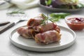 Delicious pigs in blankets, meat wrapped in bacon, homemade cooked meat bites. Bright food photo