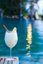 Delicious pina colada cocktail by the luxury evening pool Royalty Free Stock Photo