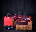 Delicious pink cake with berries on wooden table