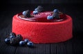 Delicious pink cake with berries on wooden table Royalty Free Stock Photo