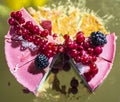 Delicious pink cheesecake with fresh berries on top, on a golden plate Royalty Free Stock Photo