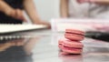 Delicious pink raspberry macaroons on the table at commercial kitchen