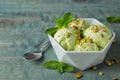 Delicious pistachio ice cream on blue wooden table