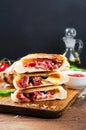 Delicious Pizza Calzone, Italian Pizza Stuffed with Ham and Cheese with Tomatoes and Fresh Basil on Wooden Background Royalty Free Stock Photo