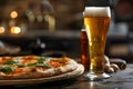 Delicious pizza with fresh basil and cold beer on wooden table Royalty Free Stock Photo