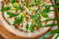 Delicious pizza with grilled chicken, avocado, and arugula