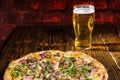 Delicious pizza with ham near a glass of beer Royalty Free Stock Photo