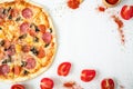 Delicious pizza with ingredients and spices on white rustic background. Flat lay, top view.