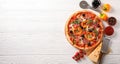 Delicious pizza and ingredients on white wooden background Royalty Free Stock Photo