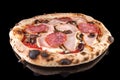 Delicious pizza with tomato sauce, mozzarella, mushrooms, chicken meat, salami, and olives,  with reflection, Royalty Free Stock Photo