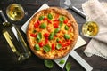 Delicious pizza with wine on table Royalty Free Stock Photo