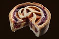 delicious plum mini pie with piece torn out of spiral dough