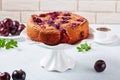Delicious plum torte on a white cake stand