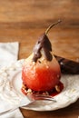 Delicious poached pear in red wine with chocolate sauce on plate Royalty Free Stock Photo