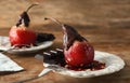 Delicious poached pear in red wine with chocolate sauce on plate Royalty Free Stock Photo