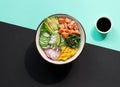 Delicious poke bowl with rice, mango, avocado, radish, chukka salad, cucumber, and marinated fresh salmon.