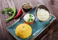 Delicious polenta - Corn porridge hominy with goat cheese, butter and sour cream on wooden background. Healthy food.