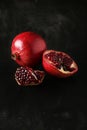 Delicious pomegranate fruit on the black background