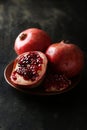 Delicious pomegranate fruit on plate on the black background Royalty Free Stock Photo