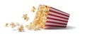 The delicious popcorn spilling from a striped container..AI generated image Royalty Free Stock Photo