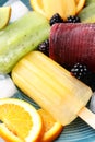 Delicious popsicle, ice cubes and fresh fruits on plate, closeup Royalty Free Stock Photo