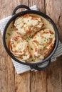 Delicious pork chops stewed in a creamy wine sauce with herbs close-up in a pan. Vertical top view Royalty Free Stock Photo