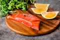 Delicious portion of fresh salmon fillet with aromatic herbs, spices and vegetables - healthy food, diet or cooking concept Royalty Free Stock Photo