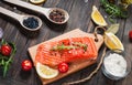 Delicious portion of fresh salmon fillet with aromatic herbs, spices and vegetables - healthy food, diet or cooking concept Royalty Free Stock Photo