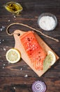 Delicious portion of fresh salmon fillet with aromatic herbs, spices and vegetables - healthy food, diet or cooking concept Royalty Free Stock Photo