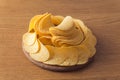 Delicious potato chips, laying on wooden table background Royalty Free Stock Photo
