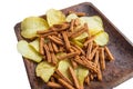 Delicious potato chips and salted rye bread crackers on a dark wooden plate, isolated on a white background by clipping Royalty Free Stock Photo