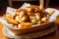 Delicious Poutine topped with fresh cheese curds, gravy, and crispy fries, served in a vintage red basket