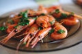 Delicious prawns with coriander in a plate on the table. Fresh seafood dish close-up