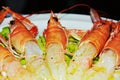 Delicious prawns, oil and salad on a white plate background