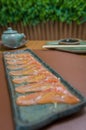 Delicious premium salmon sashimi arranged on an elegant handmade platter