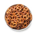 Delicious pretzel crackers in bowl isolated on white, top view Royalty Free Stock Photo