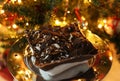 Delicious profiterole in front of the Christmas tree - homemade dessert with choux pastry and chocolate