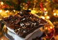 Delicious profiterole in front of the Christmas tree - homemade dessert with choux pastry and chocolate