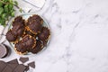 Delicious profiteroles with chocolate and mint on white marble table, flat lay. Space for text Royalty Free Stock Photo