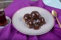 Delicious profiteroles with chocolate and plate. Delicious profiteroles with cream and chocolate glaze on a plate. Homemade