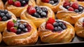 Delicious puff pastries with berries on baking sheet.