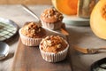 Delicious pumpkin muffins with sunflower seeds on table Royalty Free Stock Photo