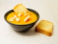 Delicious pumpkin pured soup with potatoes and zwiebacks bread slices. for vegetarian, vegan and healthy concept