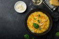 Delicious pumpkin risotto, black background