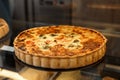 Delicious quiche with cheese and broccoli on counter in bakery shop, closeup. Space for text Royalty Free Stock Photo